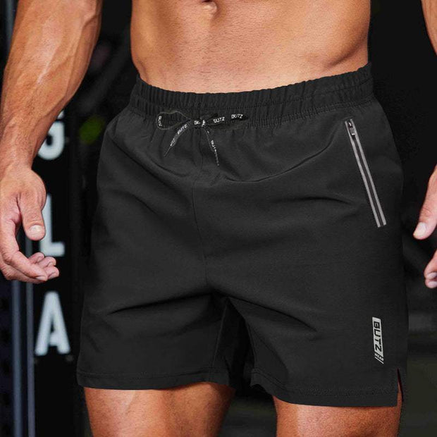 Lightweight black polyester training shorts with elastic waistband and zip pocket, ideal for performance workouts.