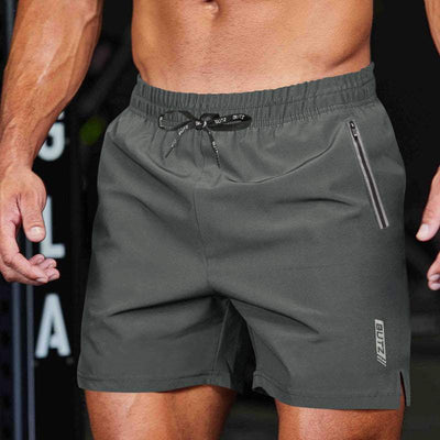 Light gray BUTZ performance training shorts with elastic waistband and zip pocket, designed for athletic use.